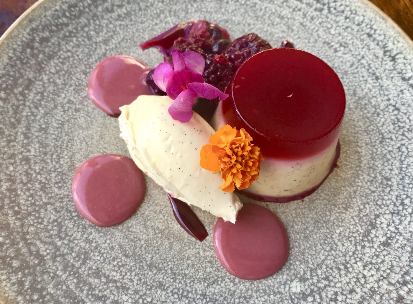 Berry panna cotta topped with edible flowers